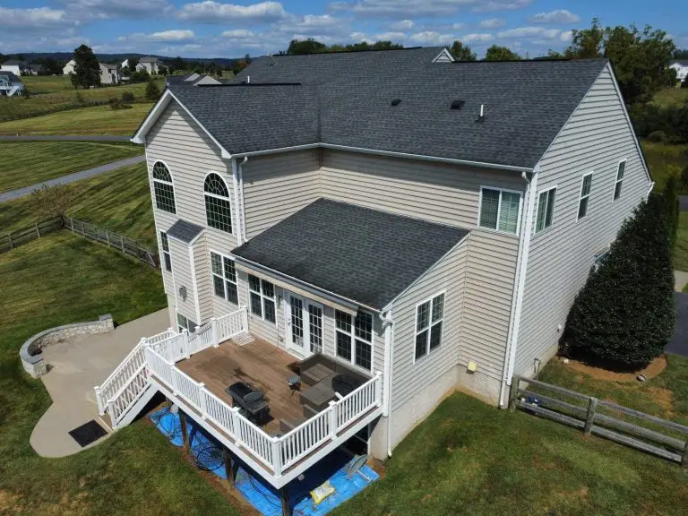 Aerial view of a two-story home and covered porch