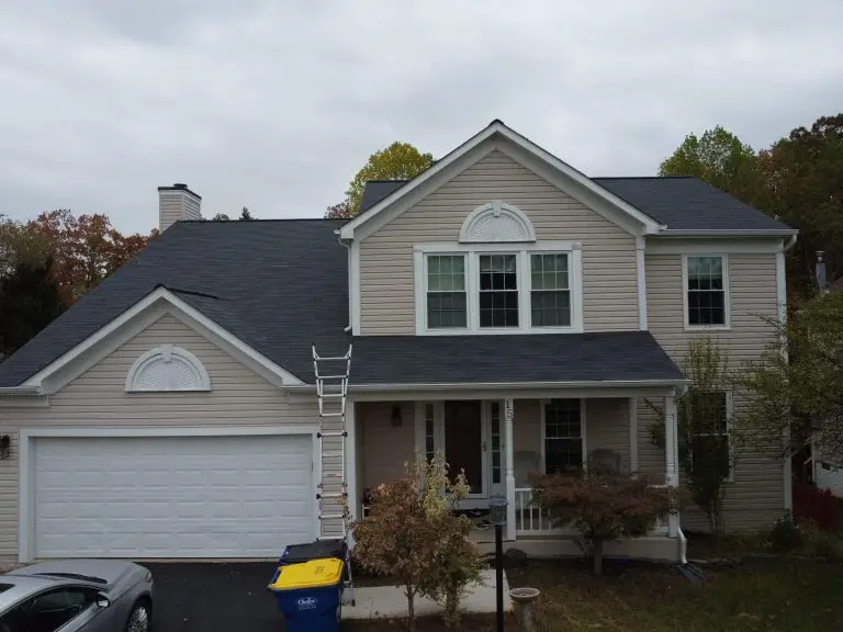 Front view of a gray-sided home with a dark roof