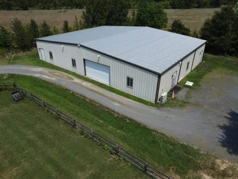 Aerial view of a white building with a low-slope roof