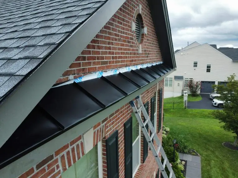 Black metal roof detail below a brick gable